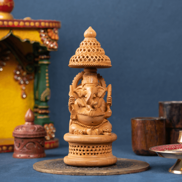 https://suryaarthandicrafts.com/wp-content/uploads/2024/10/wooden-umbrella-jali-carving-ganesh4-600x600.png