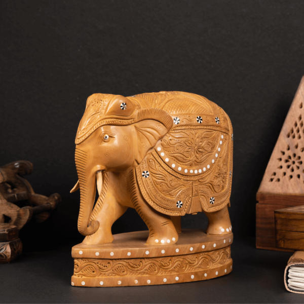 https://suryaarthandicrafts.com/wp-content/uploads/2024/12/WOODEN-FAIN-CARVING-INLY-ELEPHANT-WITH-STAND-2-600x600.png