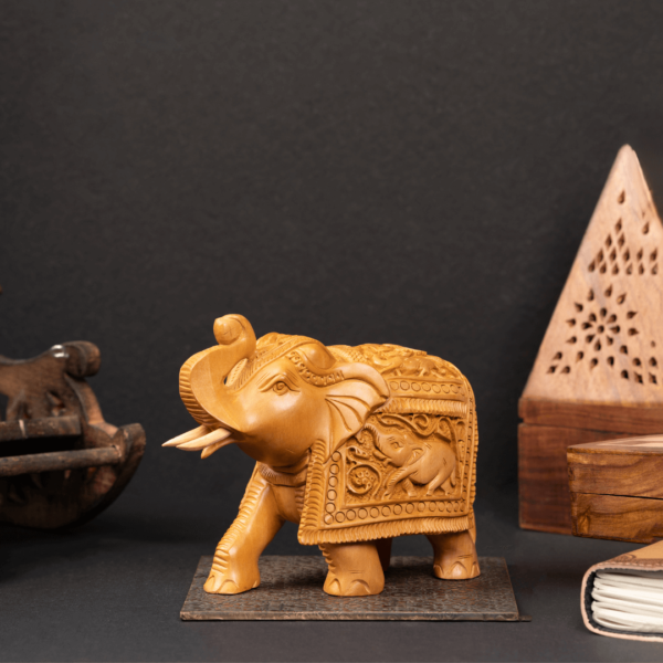 https://suryaarthandicrafts.com/wp-content/uploads/2024/12/WOODEN-FAIN-CARVING-TRUNK-UP-ELEPHANT-600x600.png