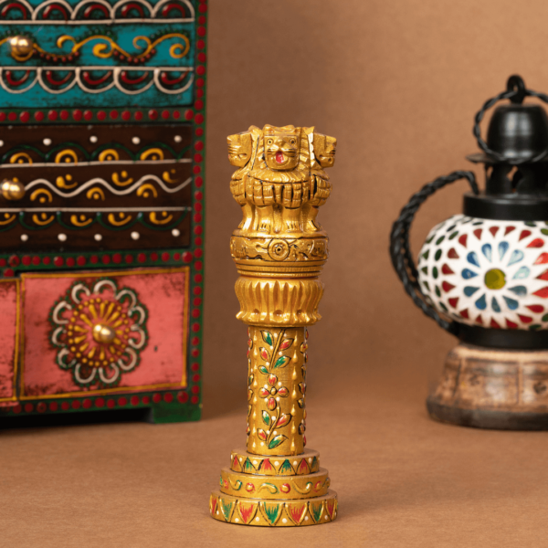 https://suryaarthandicrafts.com/wp-content/uploads/2024/12/WOODEN-FAIN-GOLD-AMBOSE-WORK-ASHOKA-PILLER-600x600.png