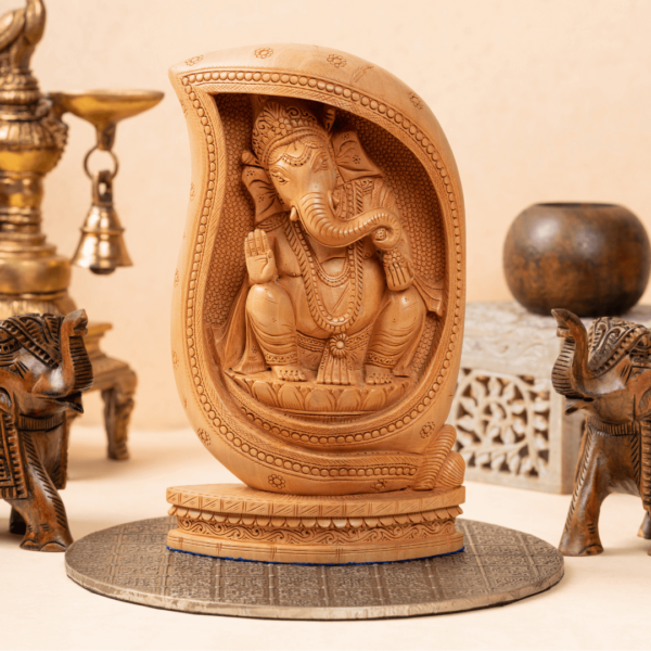 https://suryaarthandicrafts.com/wp-content/uploads/2024/12/WOODEN-FAIN-LOTOUS-CARVING-GANESH-600x600.png