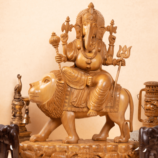 https://suryaarthandicrafts.com/wp-content/uploads/2025/01/WOODEN-FAIN-CARVING-GANESH-SITTING-ON-LION-600x600.png