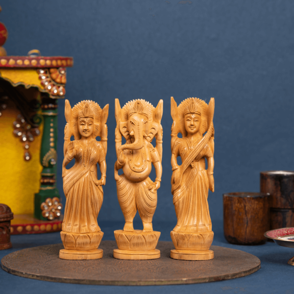 https://suryaarthandicrafts.com/wp-content/uploads/2025/01/WOODEN-FAIN-LAXMI-GANESH-AND-SARASWATI-SET-OF-3-1-600x600.png